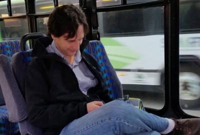 Man looking at his cell phone on SMART bus
