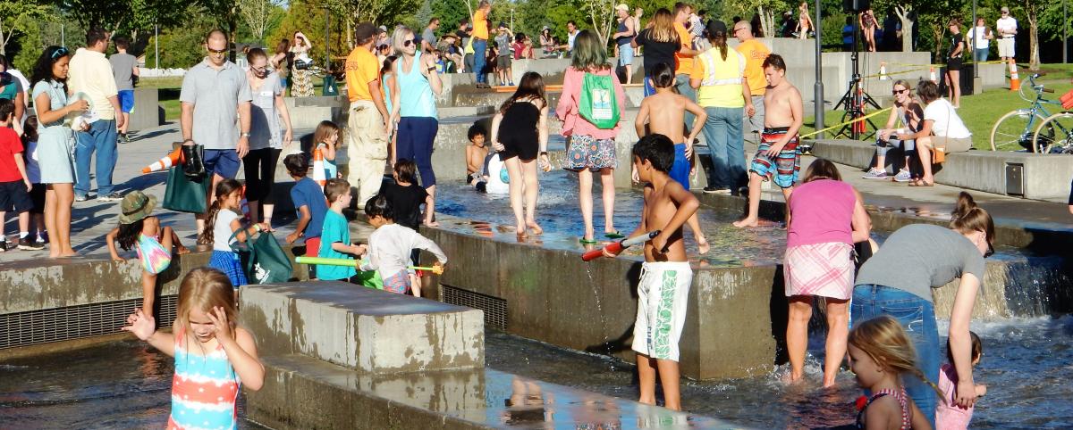 Crowd assembled at water feature during  Block Party